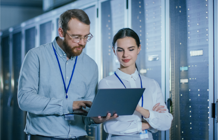 Man and a woman together looking at a laptop