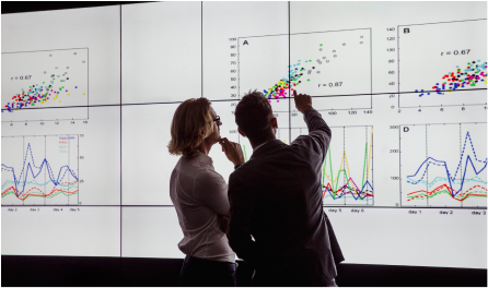 A man and a woman analysing a chart with information